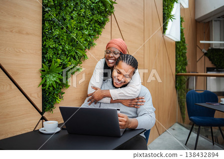 Happy couple enjoying online shopping with laptop and credit card Happy couple enjoying online shopping with laptop and credit card 138432894
