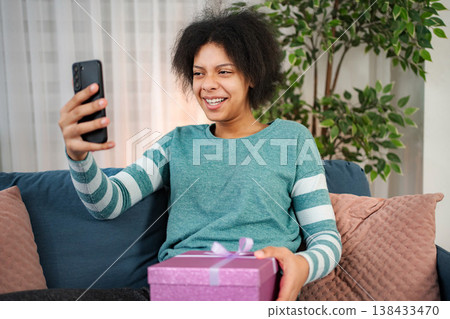 Young woman having video call sharing gift and happiness Young woman having video call sharing gift and happiness 138433470