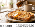 Toast with honey for breakfast, wooden table, natural light 138433480