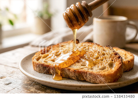 Toast with honey for breakfast, wooden table, natural light 138433480