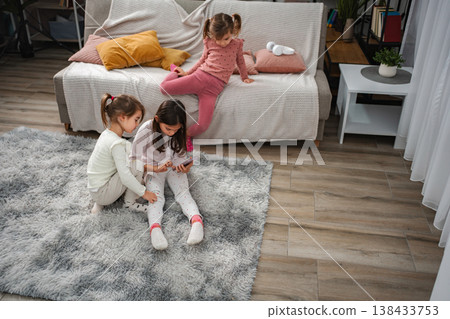 Girls playing with smartphone together at home 138433753