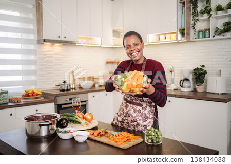 Woman cooking healthy vegan meal in modern kitchen Woman cooking healthy vegan meal in modern kitchen 138434088