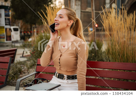 Young woman smiling talking on smartphone in Vienna Young woman smiling talking on smartphone in Vienna 138434104