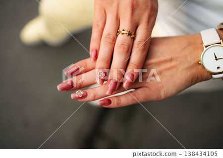Woman's hands showing manicure with elegant nail art Woman's hands showing manicure with elegant nail art 138434105
