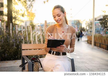 Young woman artist using digital tablet sketching outdoors in Vienna Young woman artist using digital tablet sketching outdoors in Vienna 138434115