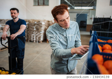 Quality control manager using digital tablet checking freshness Quality control manager using digital tablet checking freshness 138434139