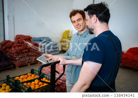 Warehouse manager and worker discussing inventory on digital tablet Warehouse manager and worker discussing inventory on digital tablet 138434141