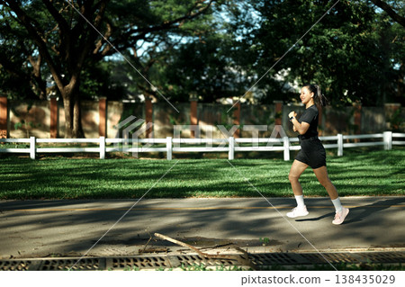 Sportswoman running in the park Sportswoman running in the park 138435029
