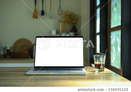 A laptop mockup on a kitchen countertop in a modern kitchen empty screen with clipping path A laptop mockup on a kitchen countertop in a modern kitchen empty screen with clipping path 138435129