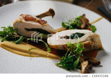 Indulge in our Gourmet Stuffed Chicken Breast, perfectly paired with a flavorful Herb Sauce Indulge in our Gourmet Stuffed Chicken Breast, perfectly paired with a flavorful Herb Sauce 138435166
