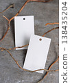 Blank gift tag mockup on grey stone with dry branches, copy space. Handmade product label 138435204