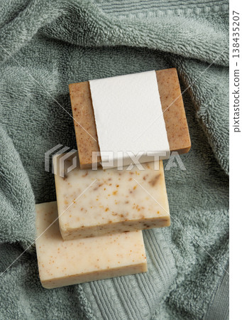 Handmade solid soap bars mockup with blank paper label on sage green bath towel, unbranded packaging Handmade solid soap bars mockup with blank paper label on sage green bath towel, unbranded packaging 138435207