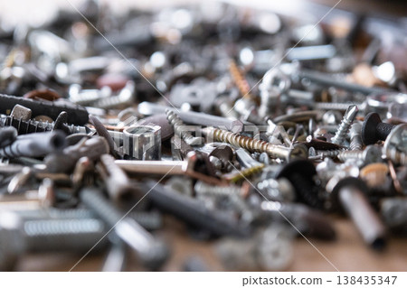 Various metal hardware items including screws, nails, nuts, washers, used in renovation, repair, assembly and industrial manufacturing processes. Various metal hardware items including screws, nails, nuts, washers, used in renovation, repair, assembly and industrial manufacturing processes. 138435347