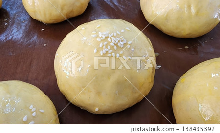 Raw Homemade Burger Buns with Sesame Seeds on Baking Sheet Ready for Oven Raw Homemade Burger Buns with Sesame Seeds on Baking Sheet Ready for Oven 138435392