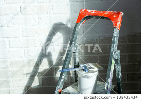 Wall painting process, step ladder, paint supply, tools for room renovation, home finish, decorating materials, interior repair work. 138435434