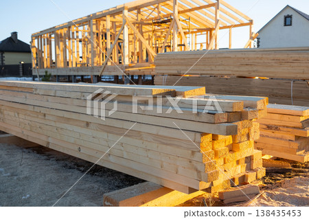 Stocked timber, beams, planks for house frame assembly, workplace, building materials, carpentry, wooden structure, foundation prep, construction site supplies. Stocked timber, beams, planks for house frame assembly, workplace, building materials, carpentry, wooden structure, foundation prep, construction site supplies. 138435453