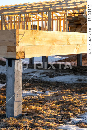 Screw pile head with timber beams, foundation detail for frame house, site assembly, platform mounting, carpentry, structural support for future building. Screw pile head with timber beams, foundation detail for frame house, site assembly, platform mounting, carpentry, structural support for future building. 138435463