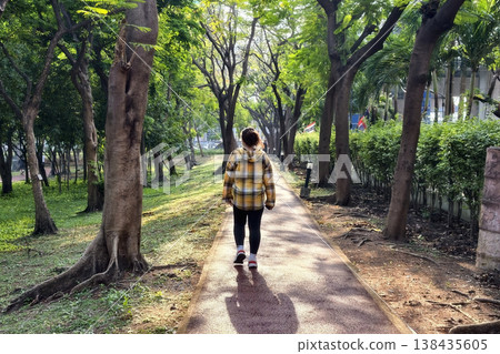 young woman walk exercise in greenery park at sunrise young woman walk exercise in greenery park at sunrise 138435605