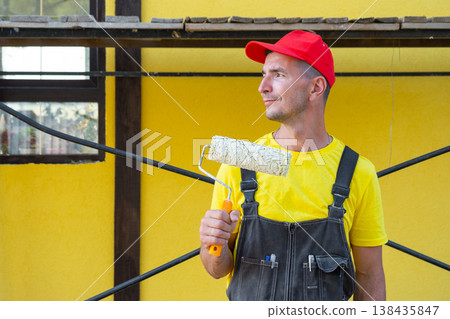 Handyman portrait, yellow shirt, trowel in hand, plastering works, self-build repair, private business, tool kit for house renovation, consultation expertise. Handyman portrait, yellow shirt, trowel in hand, plastering works, self-build repair, private business, tool kit for house renovation, consultation expertise. 138435847