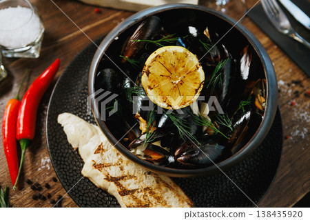 Fresh mussels with dill, lemon, and grilled bread 138435920