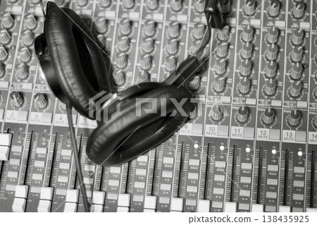 Monitor headphones placed on top of the mixing console 138435925