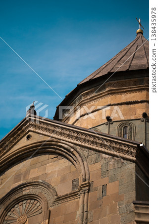 Detailed view of 11th-century Georgian Orthodox cathedral with conical dome and religious reliefs Detailed view of 11th-century Georgian Orthodox cathedral with conical dome and religious reliefs 138435978