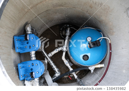 Installed equipment in artesian water well: pressure tank, filtration system, water pump, plumbing for house water supply, clean well solution. 138435982