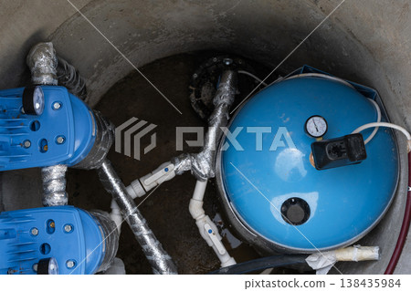 Modern water well system: hydropneumatic tank, filtration equipment, plumbing lines, pump, high-capacity water supply, domestic groundwater solution. Modern water well system: hydropneumatic tank, filtration equipment, plumbing lines, pump, high-capacity water supply, domestic groundwater solution. 138435984