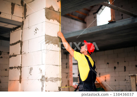 Professional takes window measurements, construction survey, size and fit check, preparing space for installation, window and door frame layout planning. Professional takes window measurements, construction survey, size and fit check, preparing space for installation, window and door frame layout planning. 138436037