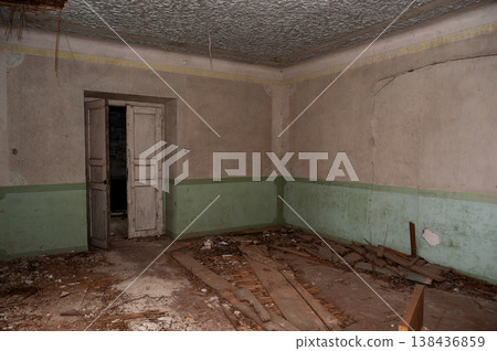 Abandoned Room With Peeling Green Paint Walls And Broken Wooden Floorboards Showing Decay And Neglect In Vintage Interior Setting 138436859