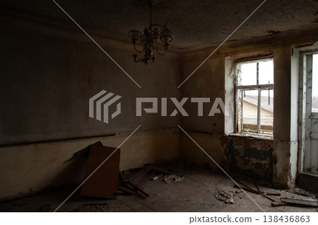 Abandoned Dilapidated Room With Peeling Paint Walls And Broken Windows Showing Decay In Dim Light Atmosphere Of Neglect 138436863