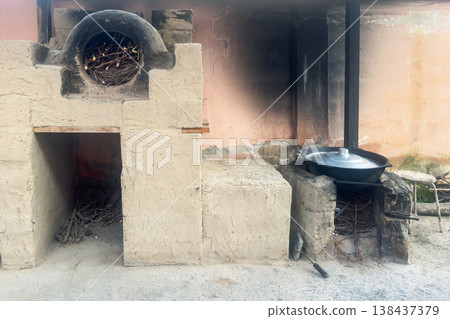 Rustic wood-burning stove sits outdoors Rustic wood-burning stove sits outdoors 138437379
