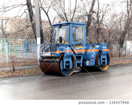 Petropavlovsk, Kazakstan - November 23, 2025: Yellow road roller machine parked on street Petropavlovsk, Kazakstan - November 23, 2025: Yellow road roller machine parked on street 138437948