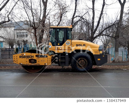 Petropavlovsk, Kazakstan - November 23, 2025: Yellow road roller machine parked on street 138437949