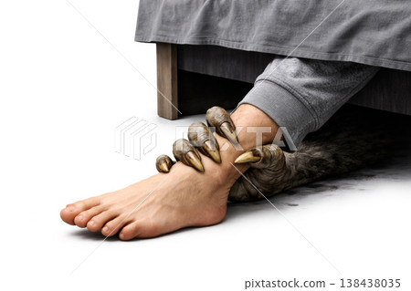 A monstrous paw with claws grabs a man by the leg under the bed. Space for text. A monstrous paw with claws grabs a man by the leg under the bed. Space for text. 138438035