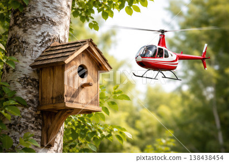 A birdhouse on a birch tree and a red helicopter nearby. 138438454