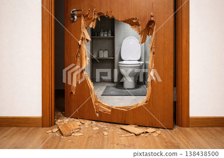 Broken wooden door to the bathroom with toilet. Broken wooden door to the bathroom with toilet. 138438500