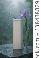 Minimalist craft paper box mockup on a wet stone with a purple iris flower in a misty garden 138438829