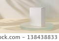 White box mockup on a frosted glass podium with soft tropical palm shadows on a beige background 138438833