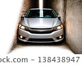 A silver car in a very narrow passage between the walls. Space for text. 138438947