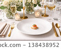 Small appetizer on a large plate on the festive table. 138438952