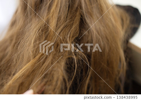 close-up of long brown hair with tangled strands 138438995