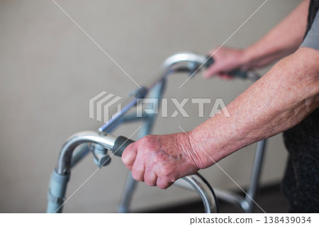 Senior woman using a walker for mobility support Senior woman using a walker for mobility support 138439034