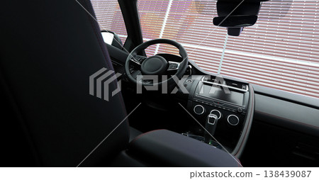 Steering wheel, head display and controls on dashboard in vehicle. View from behind drivers seat  138439087