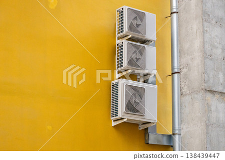 air conditioning on facade of building, air cooling in hot weather. air conditioning on facade of building, air cooling in hot weather. 138439447