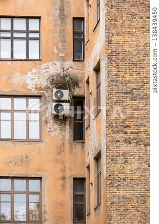air conditioning on facade of building, air cooling in hot weather. air conditioning on facade of building, air cooling in hot weather. 138439450