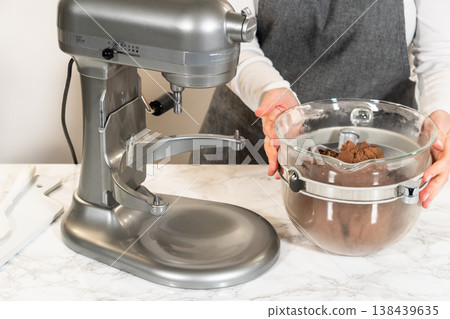 Stand mixer with butter, brown sugar, and other ingredients for Pale Gingerbread Cookies with Subtle Spice Flavor. Glass bowl on the mixer is partially filled. Stand mixer with butter, brown sugar, and other ingredients for Pale Gingerbread Cookies with Subtle Spice Flavor. Glass bowl on the mixer is partially filled. 138439635