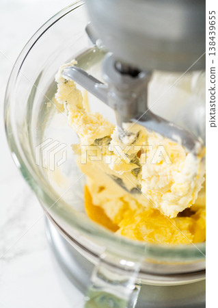 Detailed shot of whisk blending eggs in a glass mixing bowl, part of Easter Cookie Sandwich with Raspberry Buttercream process. Suitable for food blog imagery. Detailed shot of whisk blending eggs in a glass mixing bowl, part of Easter Cookie Sandwich with Raspberry Buttercream process. Suitable for food blog imagery. 138439655