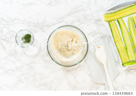 The creamy spread for Mini Cucumber Sandwiches is now fully blended and smooth. Great for step-by-step visuals in recipe blogs or instructional cooking content. 138439663