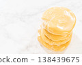 Close-up view of Classic Sugar Cookie Dough wrapped in plastic wrap, prepared for chilling in the refrigerator. This step ensures the dough firms up, making it easier to roll and cut for baking. 138439675